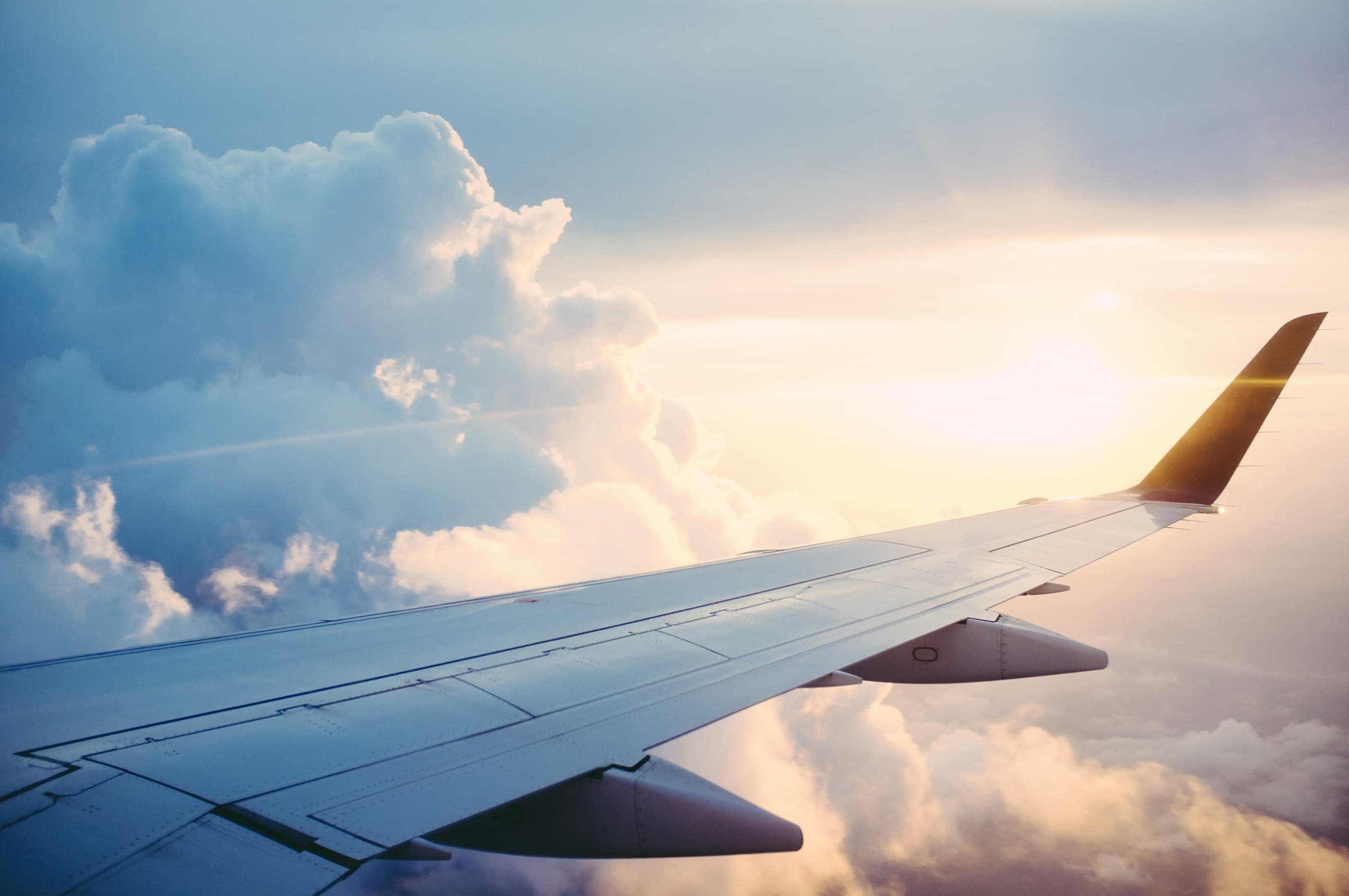 Aircraft above international cloud routes at dusk